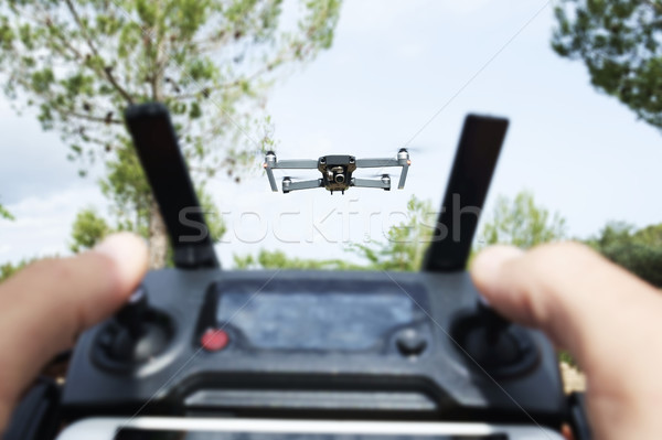 man operating a drone in a natural landscape Stock photo © nito