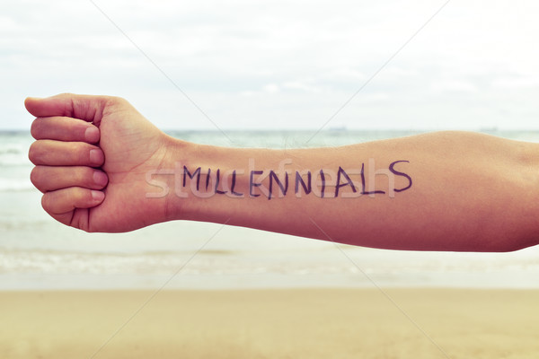 young man with the word millennials written in his arm Stock photo © nito
