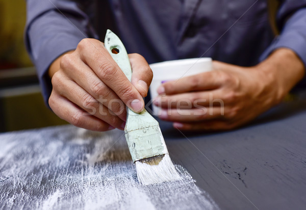 young man painting a wooden board Stock photo © nito