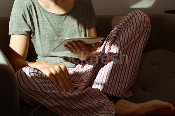 young man in pajamas using a tablet computer Stock photo © nito
