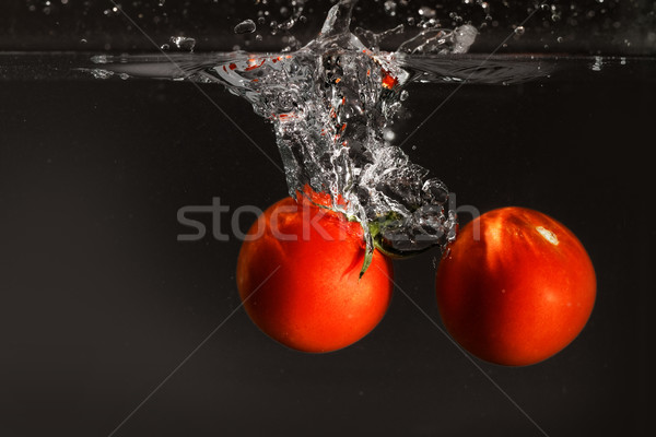 Stock photo: Fresh tomato dropped into water