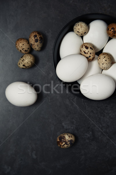 Quail and chicken eggs on a table Stock photo © Novic
