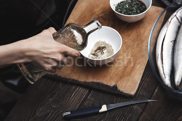 Woman preparing marinade for fish Stock photo © Novic