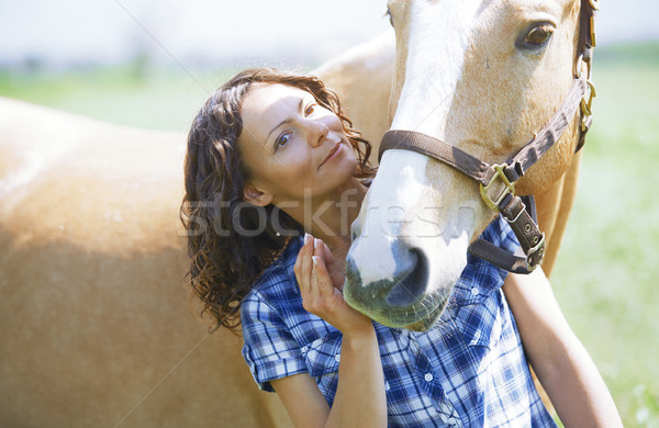 Woman and horse together at paddock Stock photo © Novic