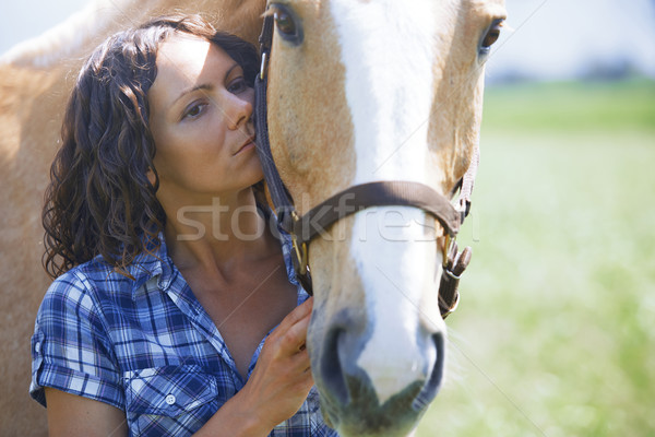 Stock photo: Woman and horse together at paddock