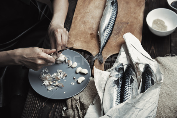 Woman preparing mackerel fish Stock photo © Novic