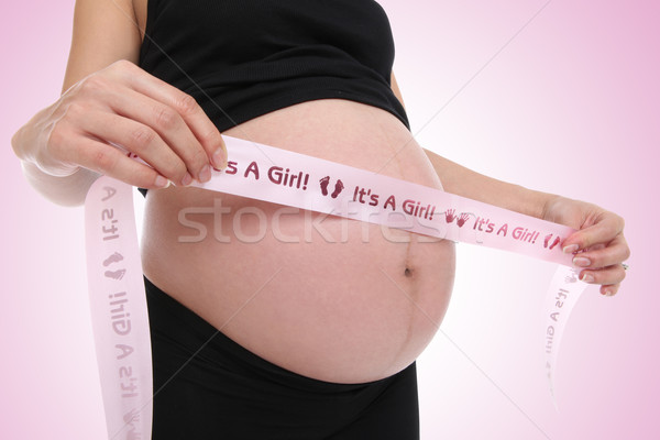 Kobieta w ciąży dziewczyna wstążka około żołądka kobieta Zdjęcia stock © nruboc