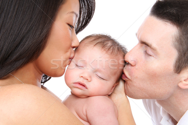 Stock photo: Parents Kissing Baby