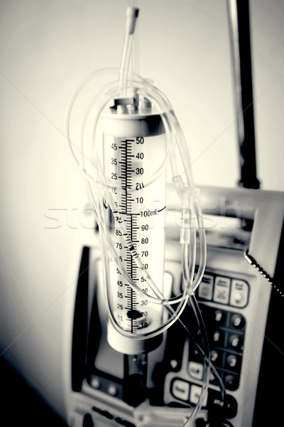Partial view of a transparent drip bag and tubing against a whit Stock photo © nuiiko
