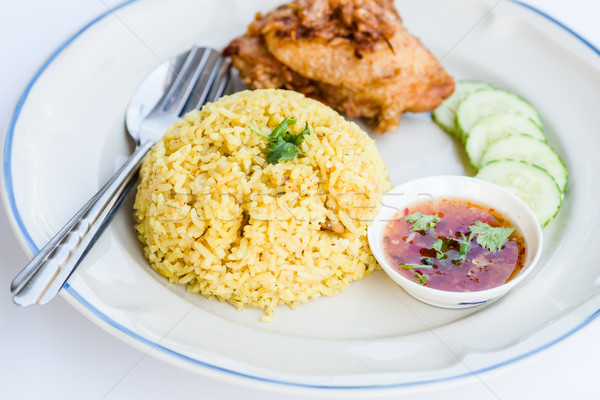 Yellow rice with fried chicken on dish. Stock photo © nuiiko