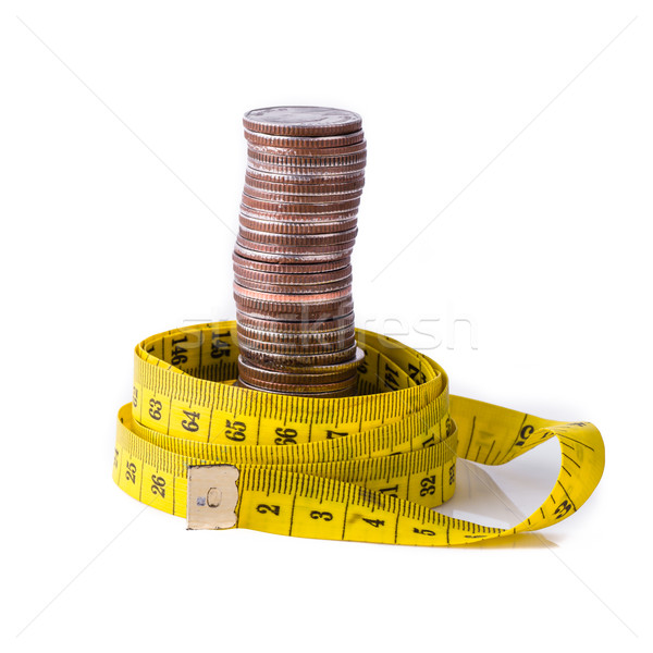 stack of coins with tape measuring isolated on white Stock photo © nuiiko