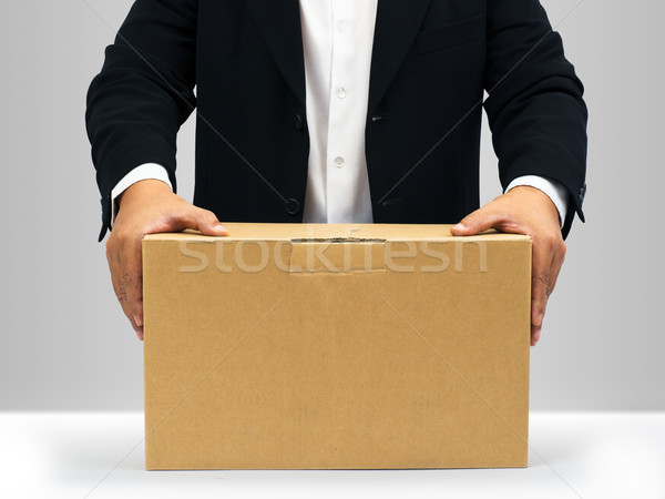 üzletemberek tart lefelé barna papír doboz fekete öltöny Stock fotó © nuttakit