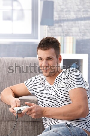 Young man enjoying computer game at home Stock photo © nyul