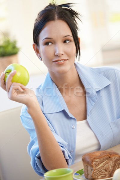 Young woman having apple for breakfast Stock photo © nyul