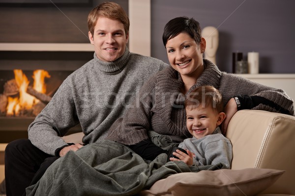 Boldog család otthon ül kanapé kandalló néz Stock fotó © nyul