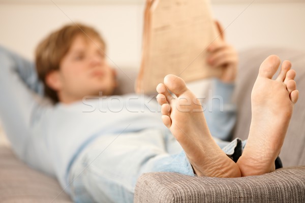 Stock photo: Man reading on sofa