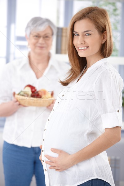 Vonzó várandós anya mosolyog boldogan anya tart Stock fotó © nyul