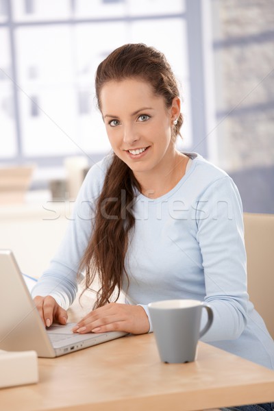 Attractive female browsing internet at home Stock photo © nyul