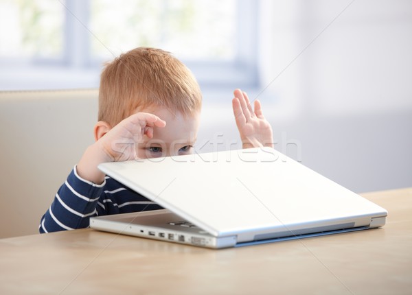 Elfish little boy playing with laptop Stock photo © nyul