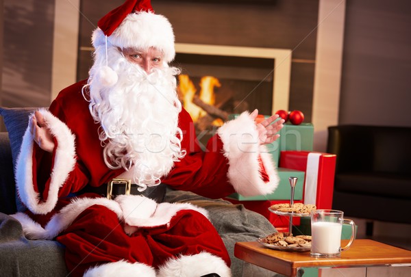 Stock photo: Happy Santa with milk and chocolate chip cookies