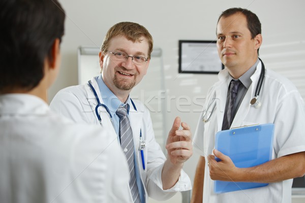 Medici consultare medical birou vorbesc zâmbitor Imagine de stoc © nyul
