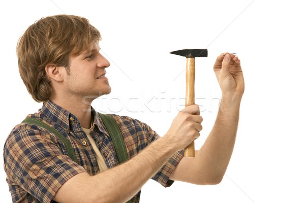 Young man hammering nail Stock photo © nyul