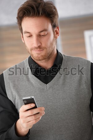 Goodlooking businessman holding mobile phone Stock photo © nyul