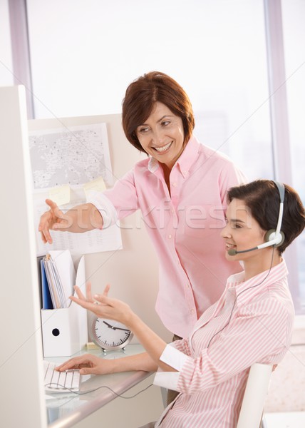 Smiling coworkers discussing work in office Stock photo © nyul