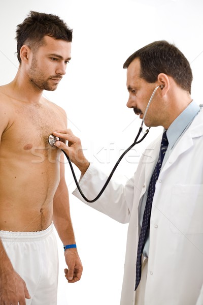 Orvos megvizsgál beteg fiatal férfi szív Stock fotó © nyul