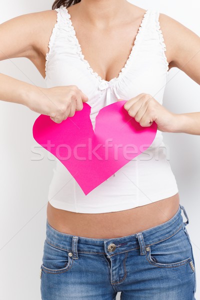 Angry female tearing paper heart apart Stock photo © nyul