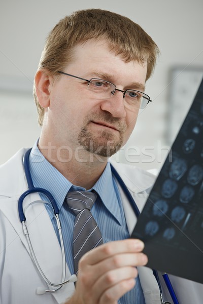 Doctor looking at medical scan Stock photo © nyul