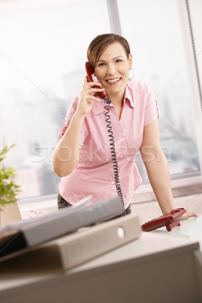 Irodai dolgozó beszél telefon boldog dől irodai asztal Stock fotó © nyul