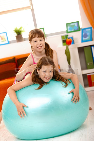 Girls playing with gym ball in living room Stock photo © nyul
