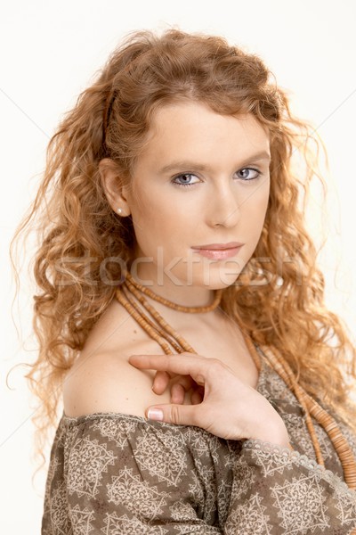 Pretty girl with long curly hair looking at camera Stock photo © nyul