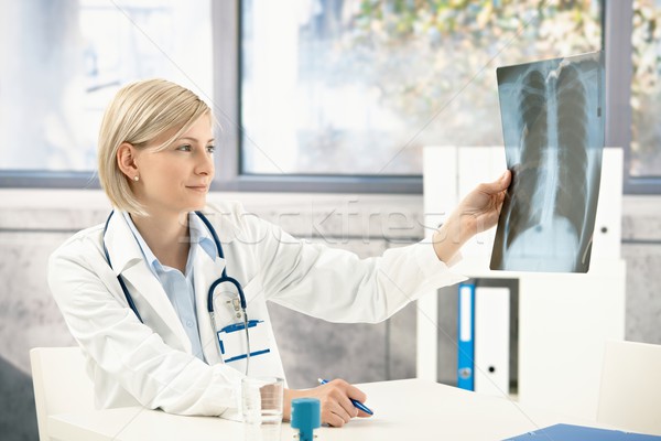 Medical doctor analysing x-ray image Stock photo © nyul