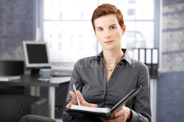 Severe young businesswoman at work Stock photo © nyul