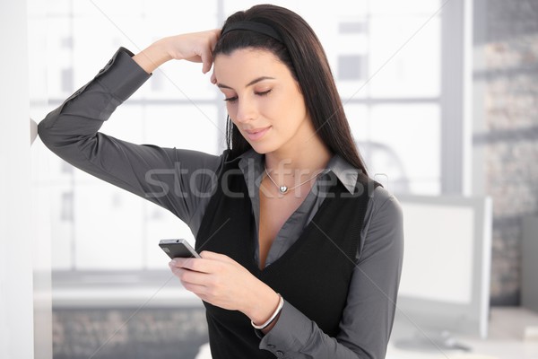 Smiling woman with mobile phone Stock photo © nyul