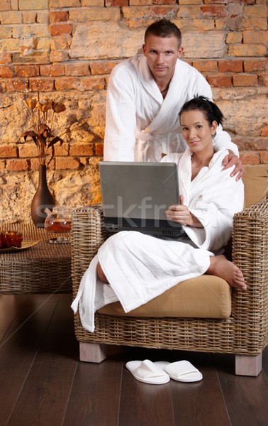 Stock photo: Portrait of bathrobe couple with laptop�