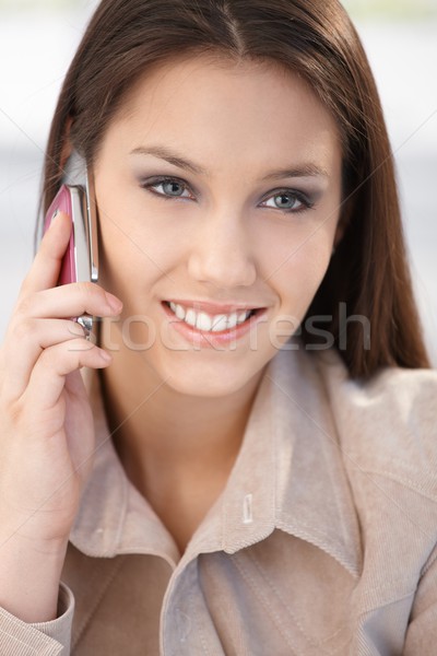 Closeup portrait of smiling woman on phone Stock photo © nyul