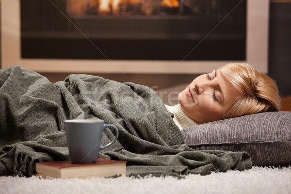 Woman sleeping beside fireplace Stock photo © nyul