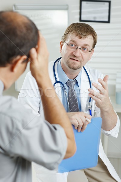 Patient telling symptoms to doctor Stock photo © nyul