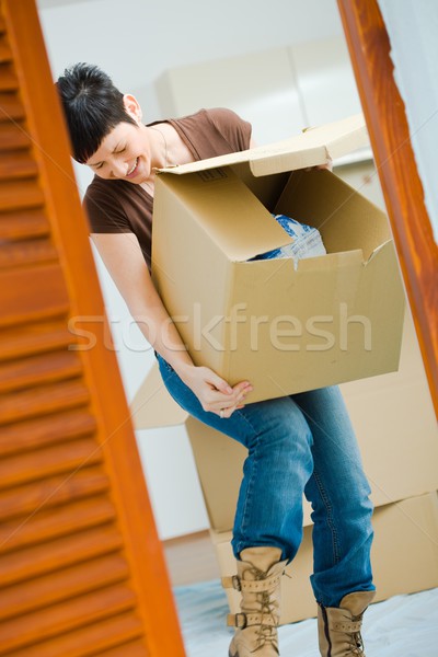 Young woman lifting cardboard box Stock photo © nyul