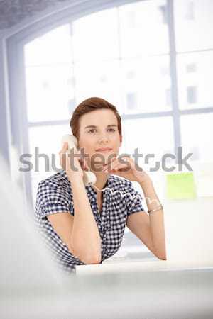 Smiling office worker on landline call Stock photo © nyul