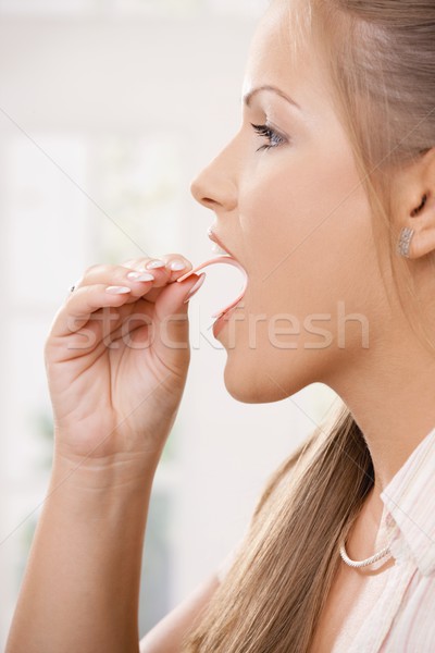 Beautiful girl taking pink chewing gum Stock photo © nyul