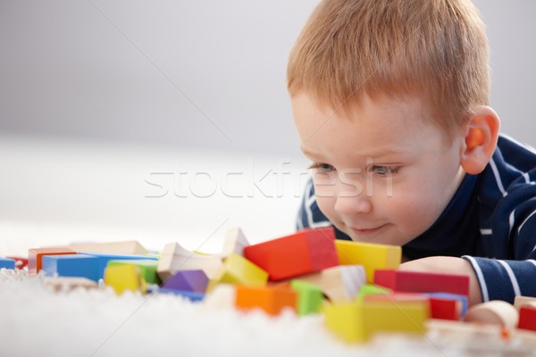 Adorable ginger-haired boy playing with cubes Stock photo © nyul