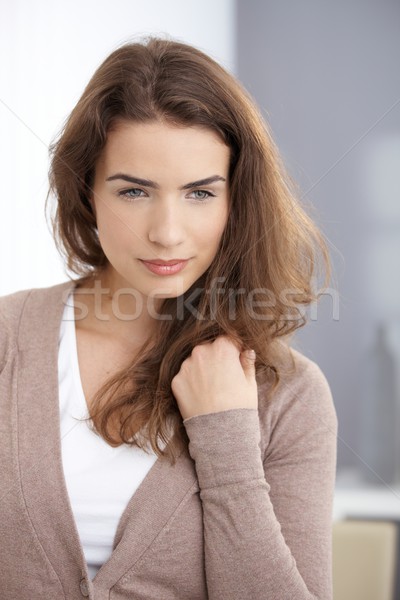 Stock photo: Daydreaming woman standing at wall