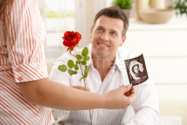 Man giving rose to pregnant woman Stock photo © nyul