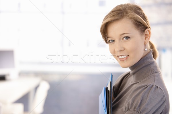 Attractive secretary holding folders Stock photo © nyul