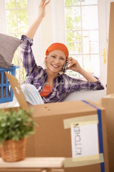Happy woman on phone at moving Stock photo © nyul