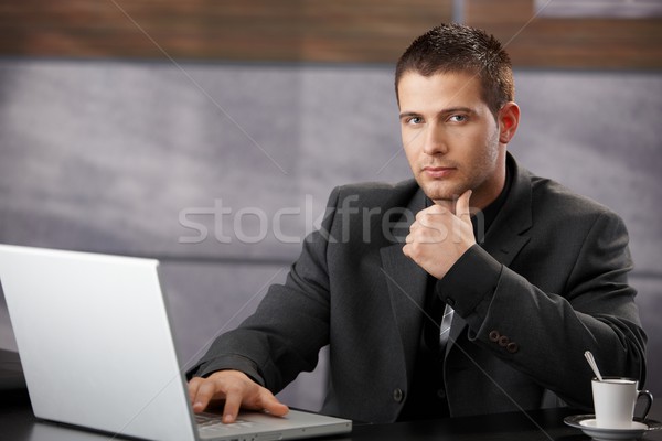 Goodlooking manager sitting at desk in office Stock photo © nyul